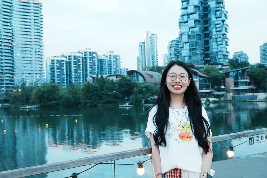 Xiangxuan Ren smiling by a lake